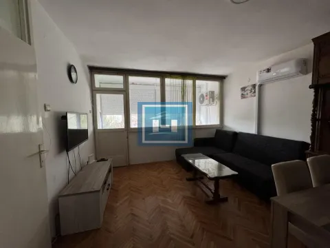 Living room with sofa set, TV stand, and access to the balcony. - image 8