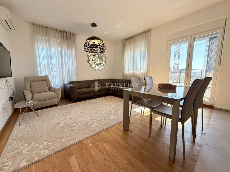 Living room with dining area and sofa set.