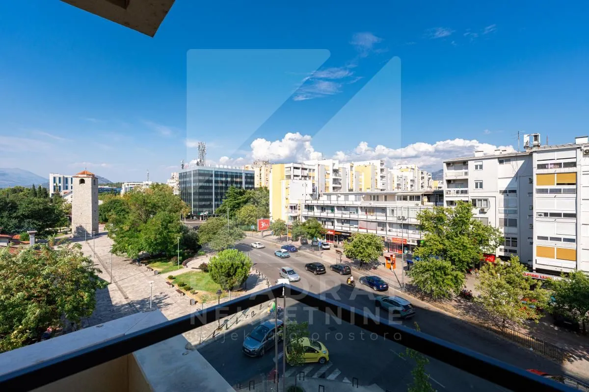 View from the terrace overlooking the city street and surrounding buildings.
