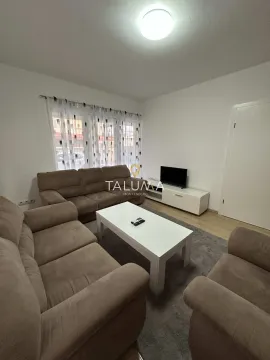 Living room with a sofa set, a white coffee table, and a TV. - image 20