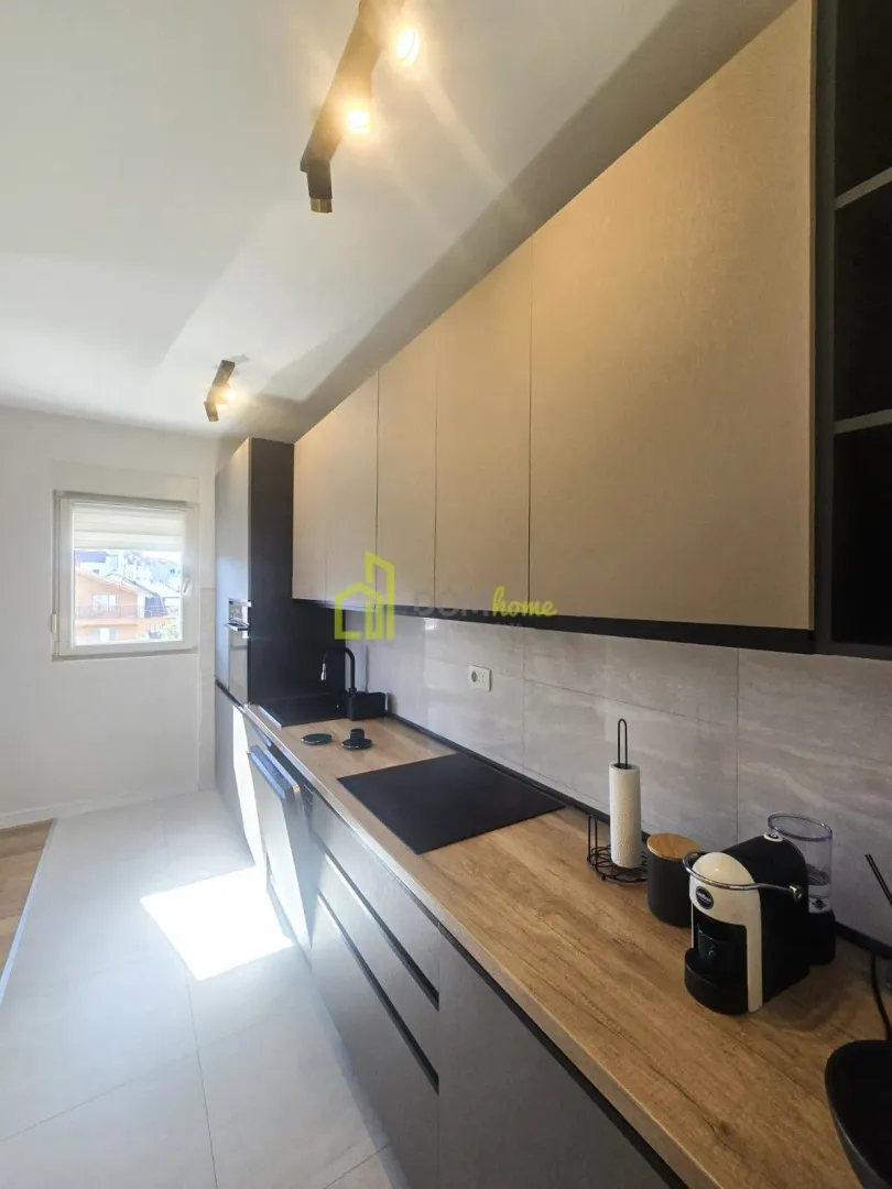 Modern kitchen with built-in cabinetry and a wooden countertop.