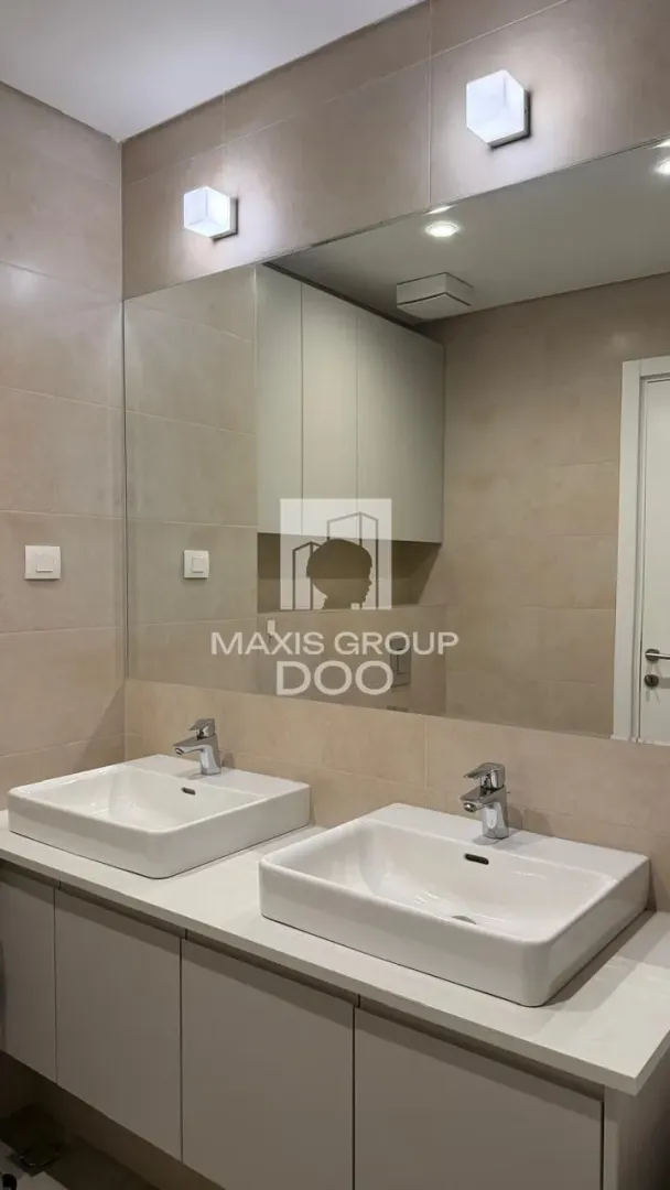 Modern bathroom with double sinks and a large mirror.