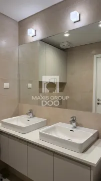 Modern bathroom with double sinks and a large mirror. - image 9