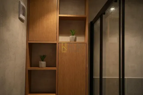 Modern wooden shelving and walk-in shower in the bathroom. - image 2