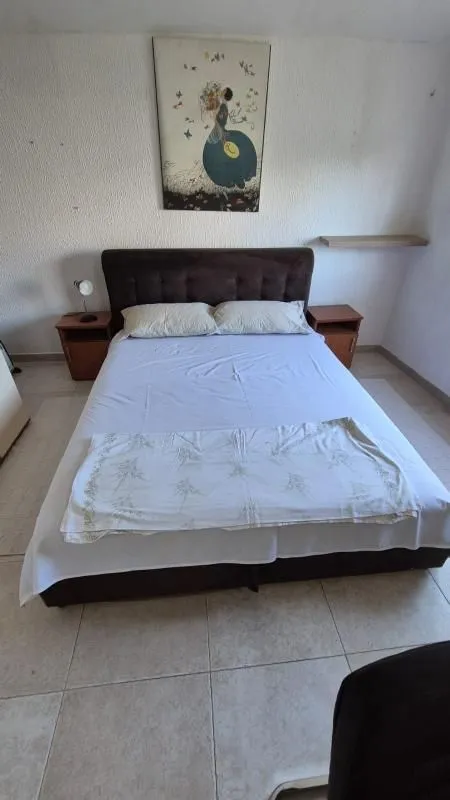 Furnished bedroom with a double bed and two bedside tables.