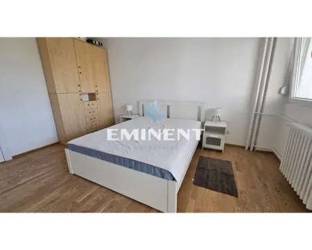 Bedroom with a double bed, wooden wardrobe and laminate flooring. - image 6