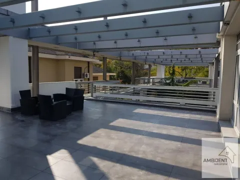 Large terrace with a pergola structure and seating furniture. - image 15