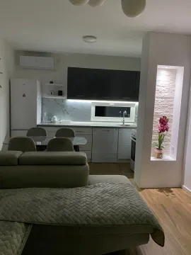 Modern kitchen with dining area and living room. - image 10
