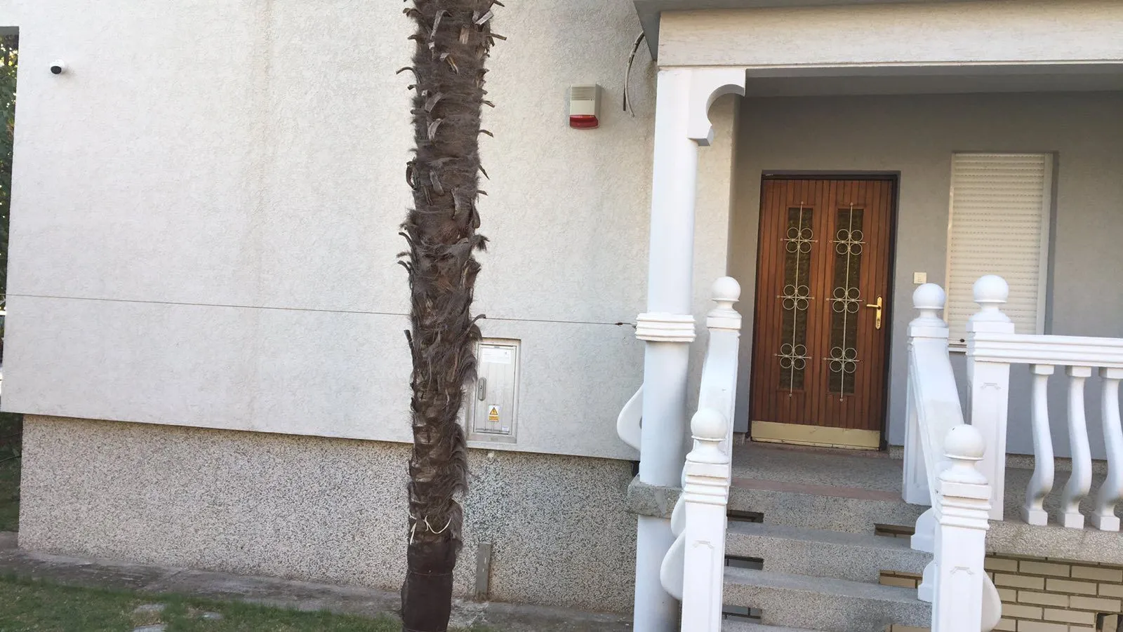 Entrance door of the house with stairs.