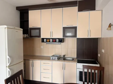 Small kitchen with fitted units, refrigerator and stove. - image 3