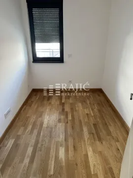 Empty room with parquet flooring and a window. - image 5