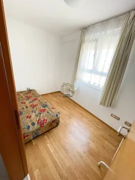 Smaller bedroom with a bed and wooden floor. - image 3