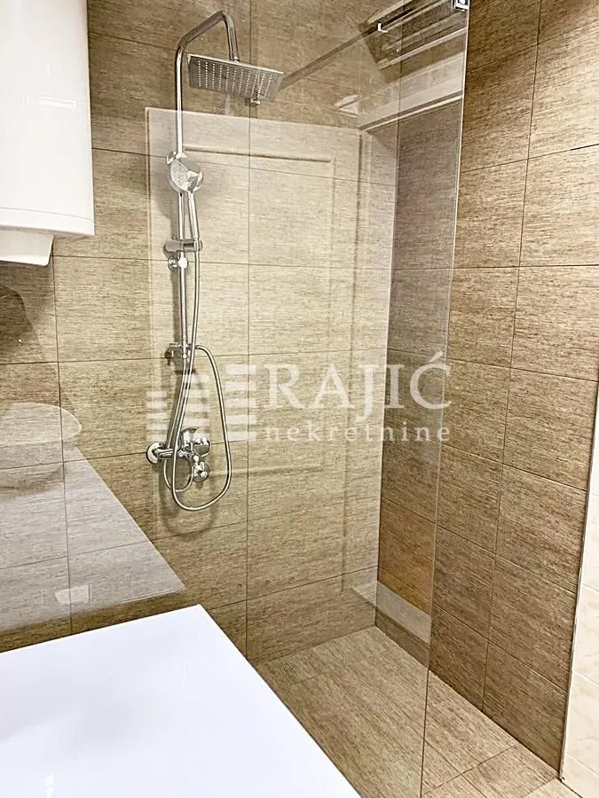 Modernly equipped bathroom with a walk-in shower.