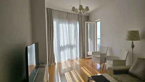 Living room with sofa, television, and access to the terrace. - image 4