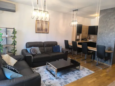 Spacious living room with a sofa set and dining area. - image 2