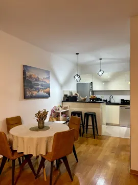 Dining area with a table and chairs overlooking the kitchen. - image 7