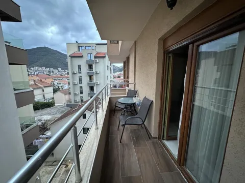 Furnished balcony with seating set and city view. - image 8