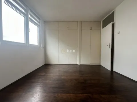 Empty bedroom with built-in wardrobes and dark wooden flooring. - image 10