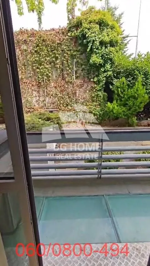 View from the balcony overlooking the yard and green areas.