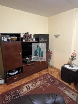 Living room with wooden furniture, a television, and a rug on the floor. - image 3