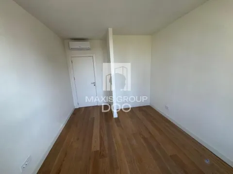 Empty room with wooden flooring and an air conditioning unit. - image 13