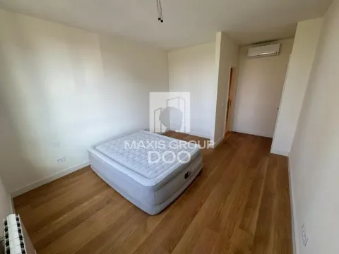 Empty bedroom with a bed and wooden flooring. - image 9