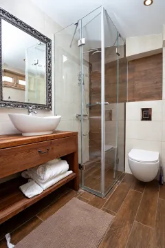 Modern bathroom with wooden elements, a walk-in shower, and a washbasin. - image 12