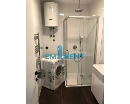 Bathroom with a shower cabin, water heater, and washing machine. - image 6