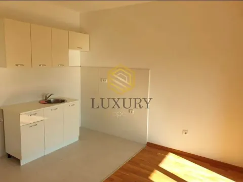 Small kitchen within a room with hardwood flooring. - image 4