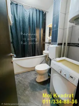 Kupatilo opremljeno kadom, toaletom i veš mašinom. - image 12