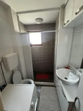 Small and functional bathroom with a shower cabin and a washing machine. - image 6