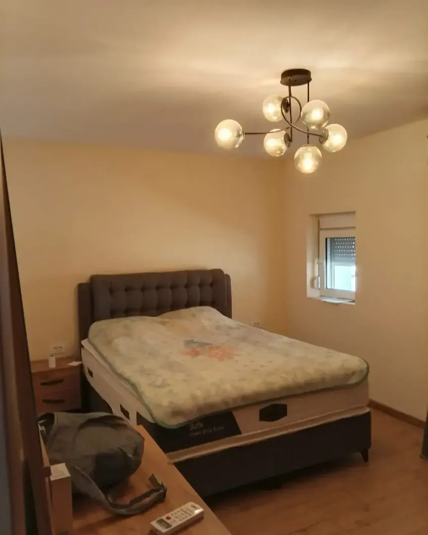Bedroom with a double bed and a chandelier.