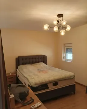 Bedroom with a double bed and a chandelier. - image 2