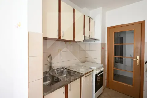 Small kitchen with a sink, cabinetry, and a stove. - image 5