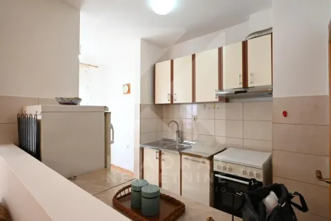 Small kitchen with white cabinets, stove, refrigerator, and sink. - image 6