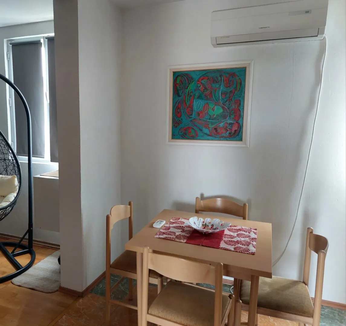 Dining area with a wooden table and four chairs.