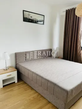 Furnished bedroom with a double bed and a nightstand. - image 4