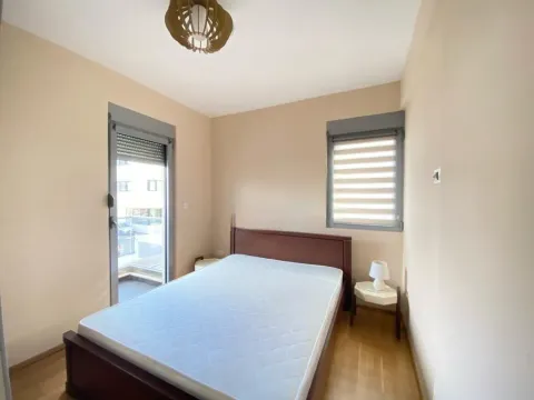 Furnished bedroom with a double bed and two windows. - image 6
