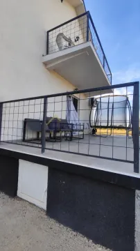 House terrace with seating furniture and metal railing. - image 12