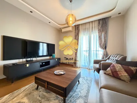 Modern living room with a sofa set, TV unit, and access to the terrace. - image 4
