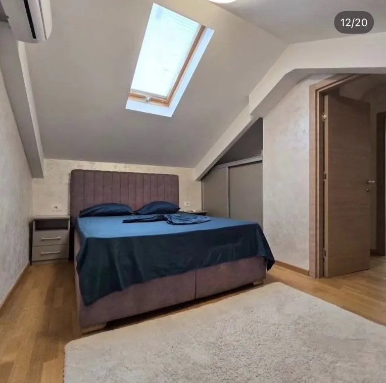 Attic bedroom with a double bed and a skylight.