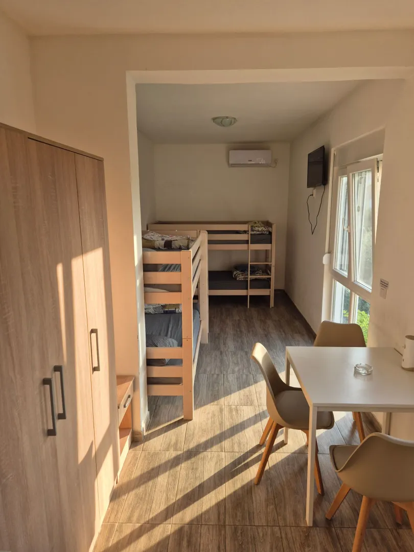 Bedroom with bunk beds and a dining table.