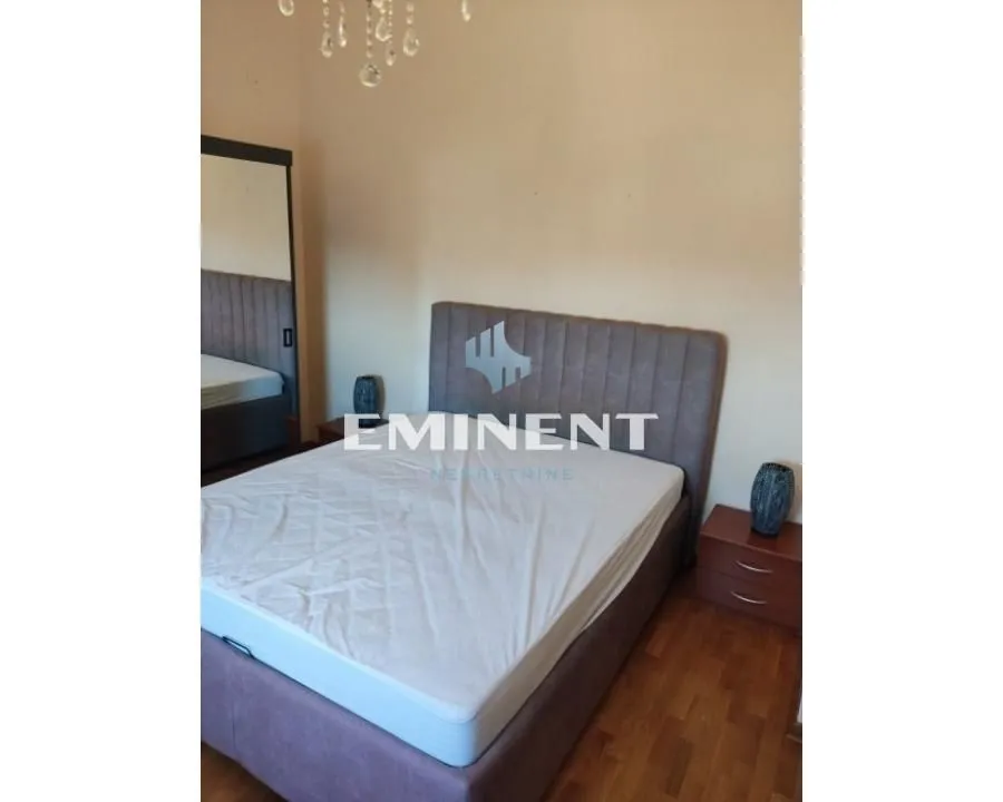 Furnished bedroom with a double bed and nightstands.