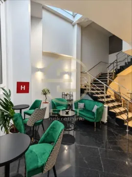 Living room with green armchairs, coffee table and stairs. - image 5