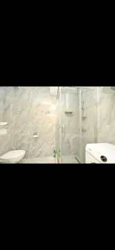 Modernly equipped bathroom with a shower cabin and ceramic tiles. - image 2
