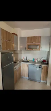 Small kitchen with wooden elements and built-in appliances. - image 3