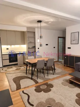 Living room with dining area and kitchen in the background. - image 6