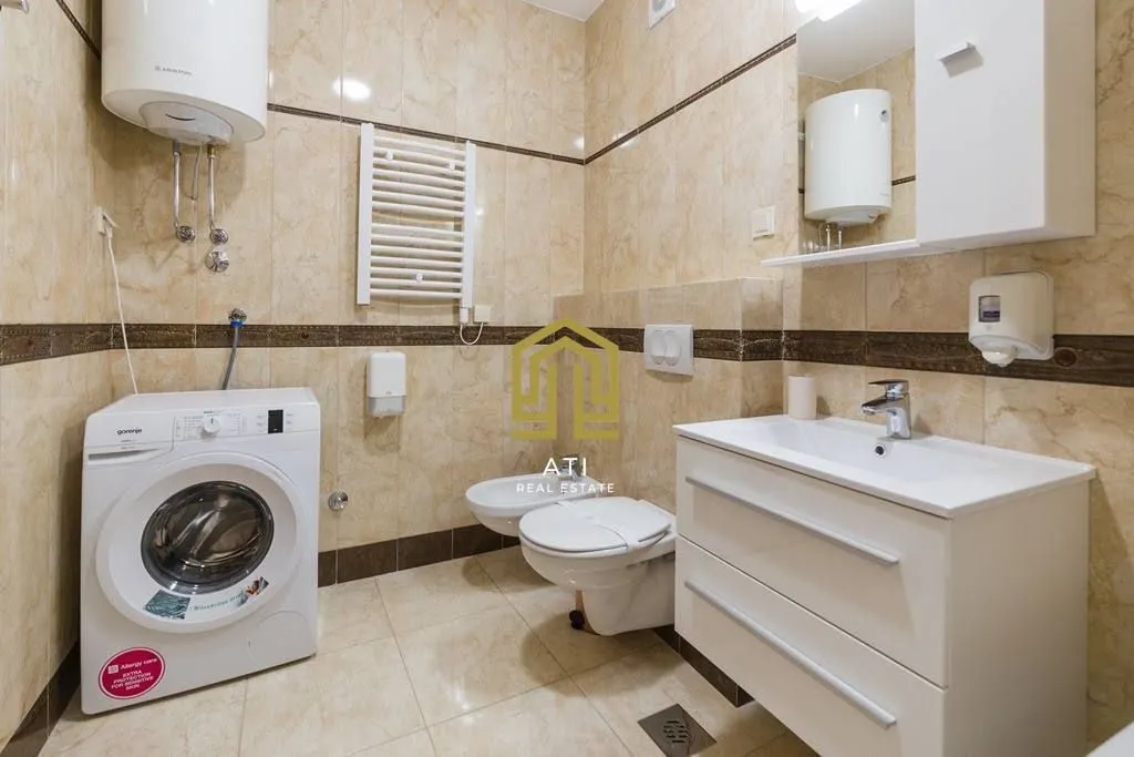 Fully equipped bathroom with sanitary fixtures, washbasin, and washing machine.