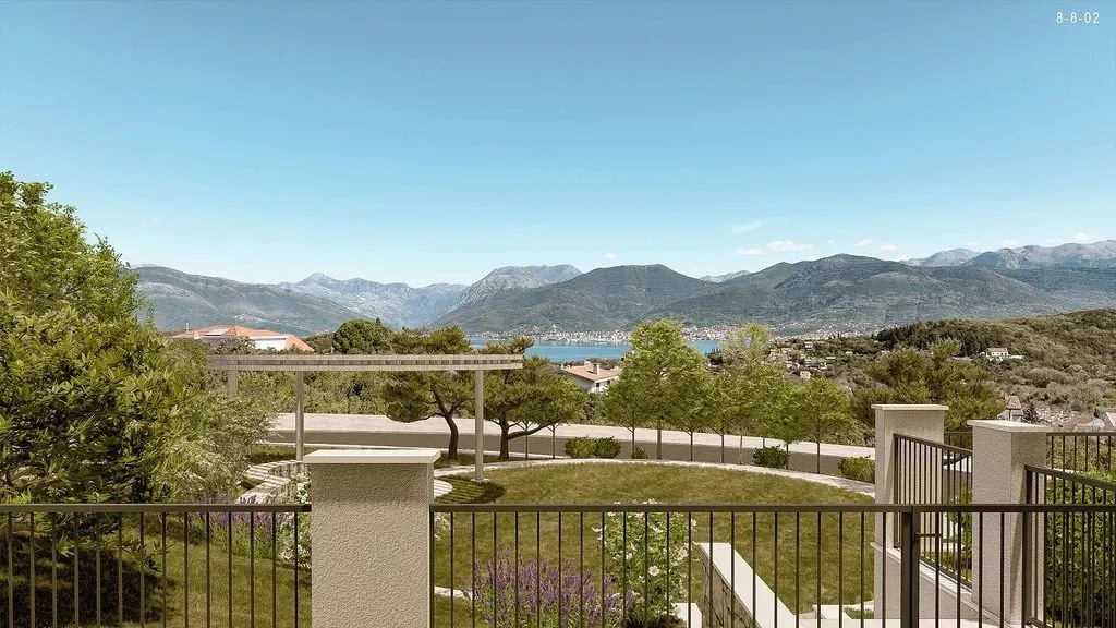 Beautiful view from the terrace overlooking the landscaped yard, sea, and mountains.