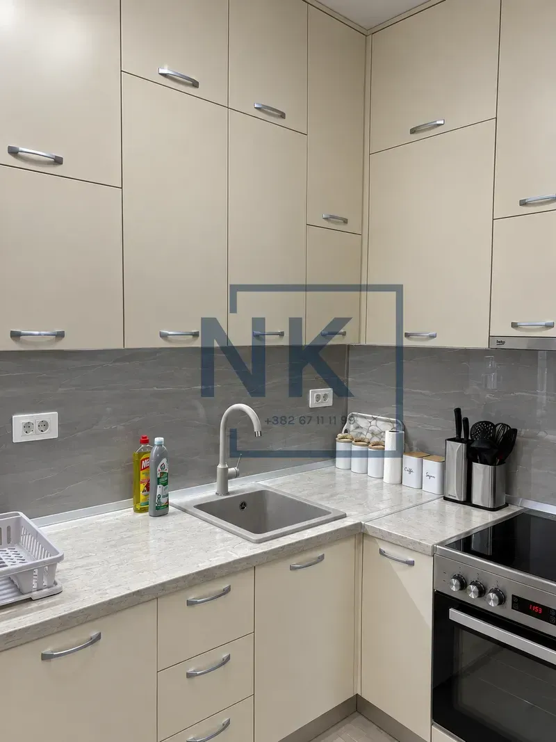Kitchen equipped with light-colored cabinetry and built-in appliances.